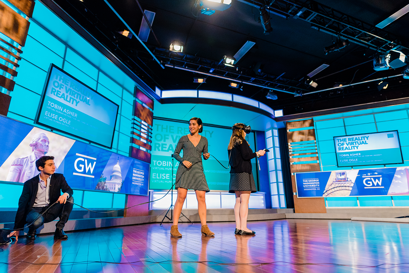 Tobin Asher (left) and Elise Ogle (center) from Stanford&#039;s Virtual Human Interaction Lab give a live virtual reality demonstration to showcase data storytelling.